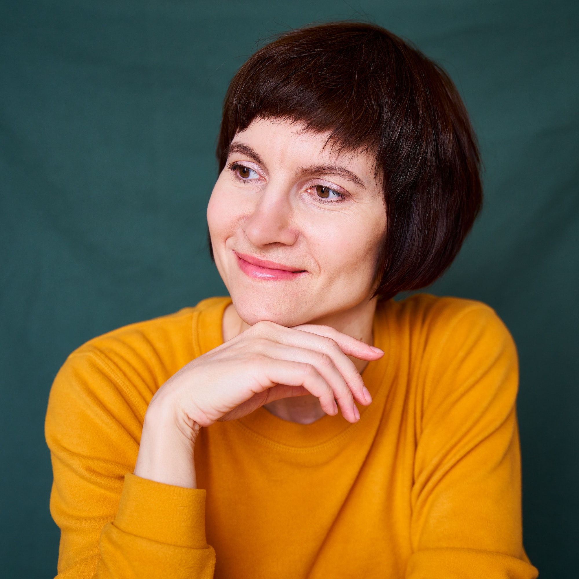 smiling mature brunette woman looking away playful and defiant close up face.jpg